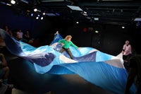 a person is holding a large blue and white cloth