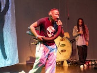 a man is holding a microphone while a woman is on stage