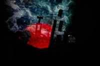 a person is standing in front of a clock tower