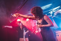 a woman on stage with a microphone in her hand