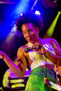 a woman singing into a microphone at a concert