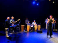 a group of people on stage with musical instruments